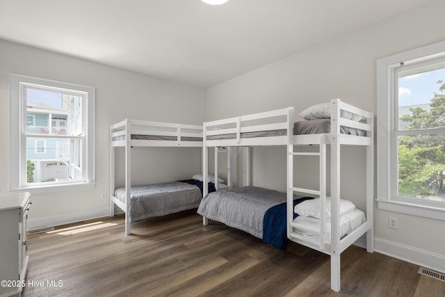 768 S Lumina Ave, Wrightsville Beach, NC 28480 - bedroom featuring multiple windows, wood finished floors, and baseboards