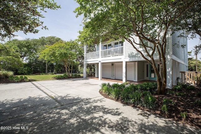768 S Lumina Ave, Wrightsville Beach, NC 28480 - view of front of home featuring driveway, a garage, and a balcony