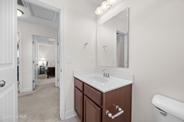 bathroom with vanity, toilet, baseboards, and visible vents