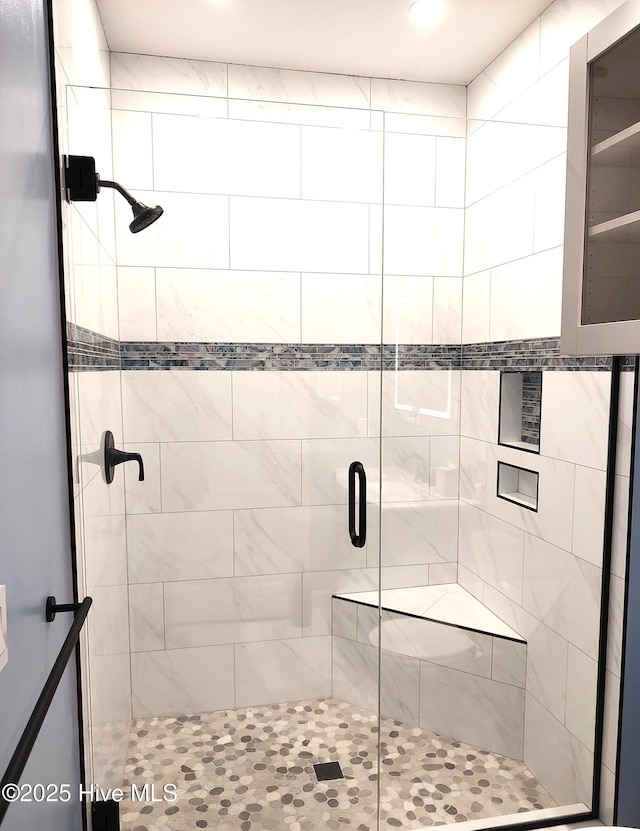 bathroom featuring a shower stall