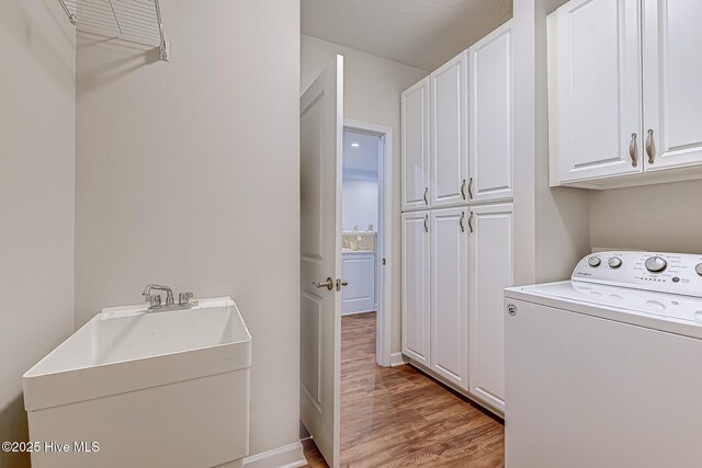290 Woodlands Way Unit 10, Calabash, NC 28467 - laundry area featuring washer / dryer, cabinet space, wood finished floors, and baseboards