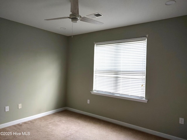 unfurnished room featuring carpet flooring, a ceiling fan, baseboards, and visible vents