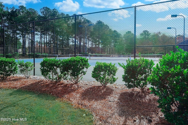 view of tennis court featuring fence
