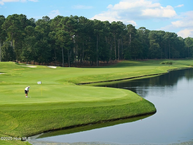 view of home's community featuring view of golf course, a water view, and a yard