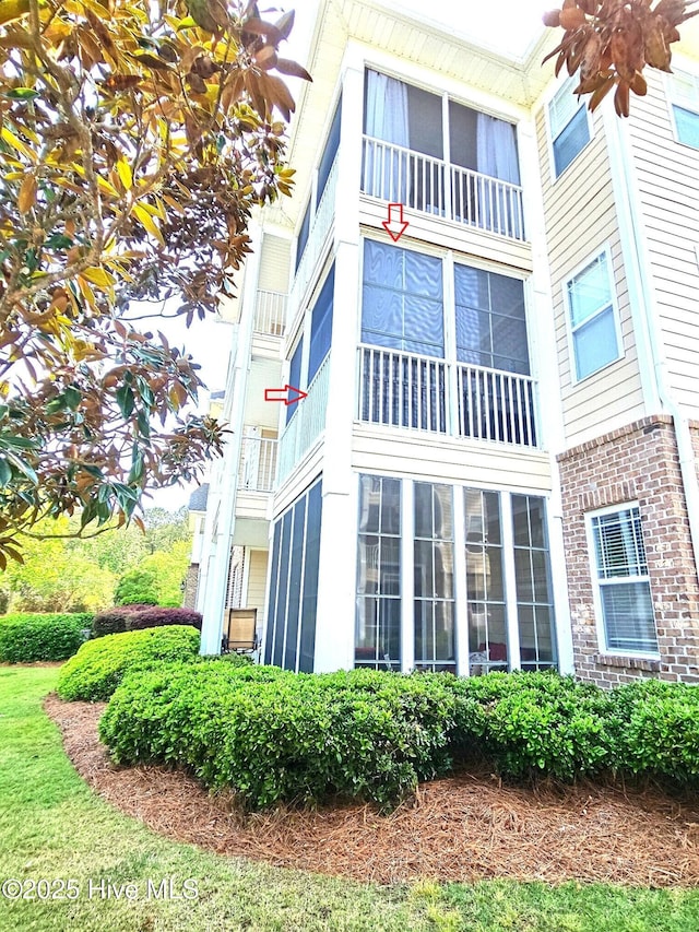 view of side of home featuring brick siding