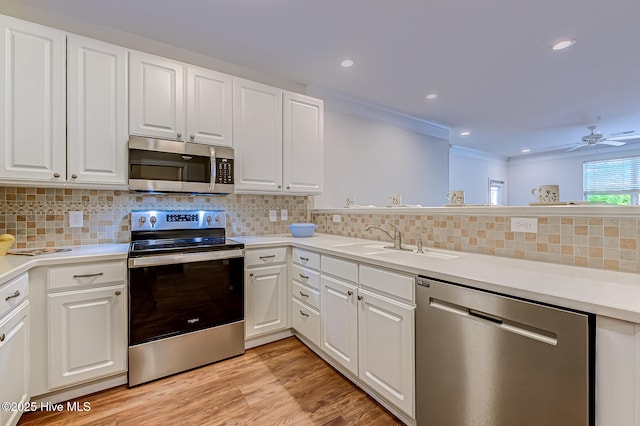 290 Woodlands Way Unit 10, Calabash, NC 28467 - kitchen with appliances with stainless steel finishes, a sink, white cabinets, ceiling fan, and tasteful backsplash