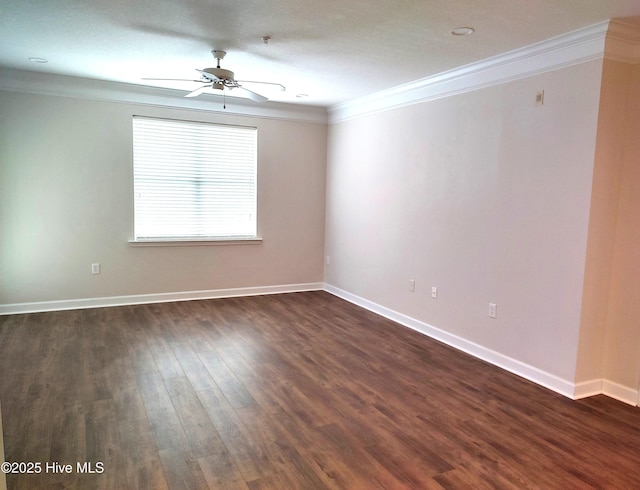 spare room featuring crown molding, dark wood-style flooring, ceiling fan, and baseboards