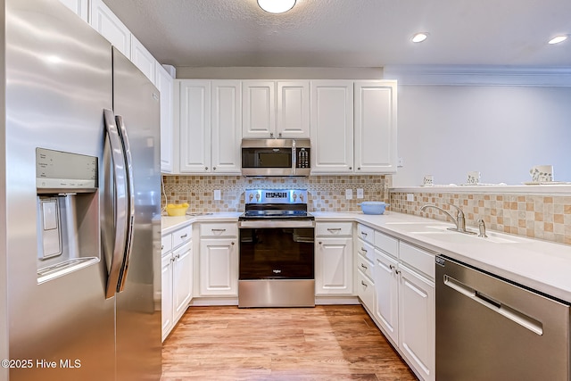 290 Woodlands Way Unit 10, Calabash, NC 28467 - kitchen with stainless steel appliances, light countertops, white cabinets, decorative backsplash, and recessed lighting