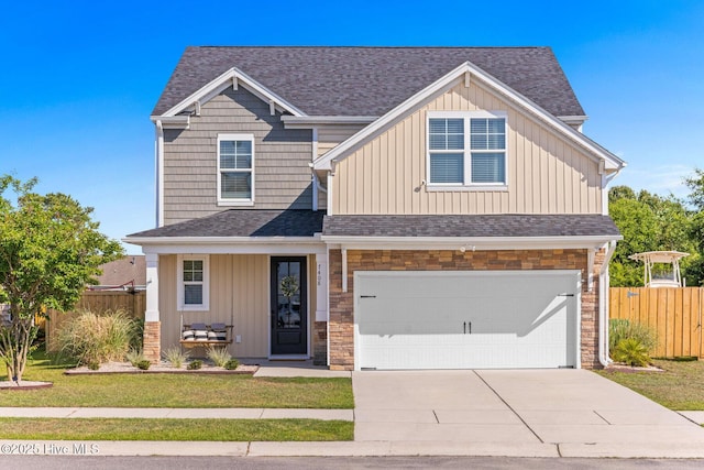 craftsman-style house featuring fence, roof with shingles, an attached garage, concrete driveway, and covered porch