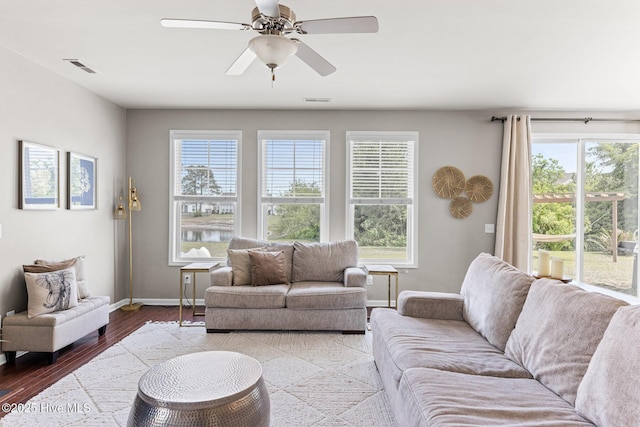 7408 Darius Dr, Wilmington, NC 28411 - living room featuring baseboards, healthy amount of natural light, wood finished floors, and a ceiling fan