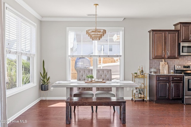 kitchen with dark brown cabinetry, stainless steel appliances, dark wood-type flooring, and a chandelier
