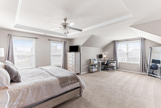carpeted bedroom featuring a tray ceiling, ceiling fan, and baseboards