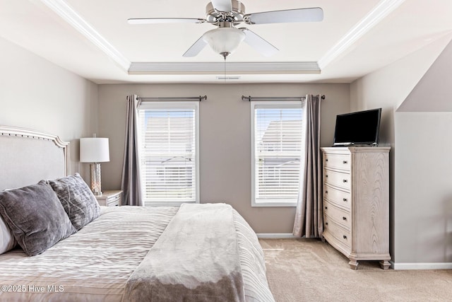 bedroom with crown molding, baseboards, light carpet, and a tray ceiling