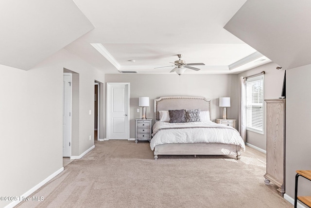 carpeted bedroom featuring a raised ceiling, baseboards, ceiling fan, and visible vents
