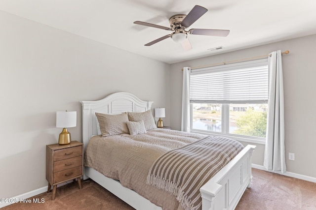 bedroom with baseboards, light carpet, and multiple windows