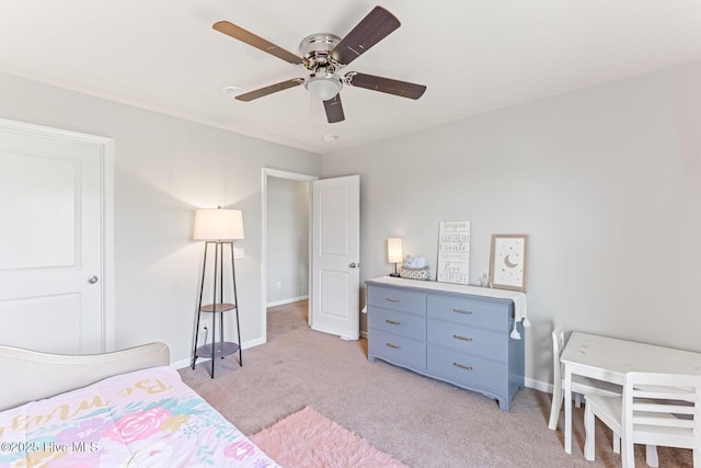 bedroom featuring baseboards, ceiling fan, and light carpet