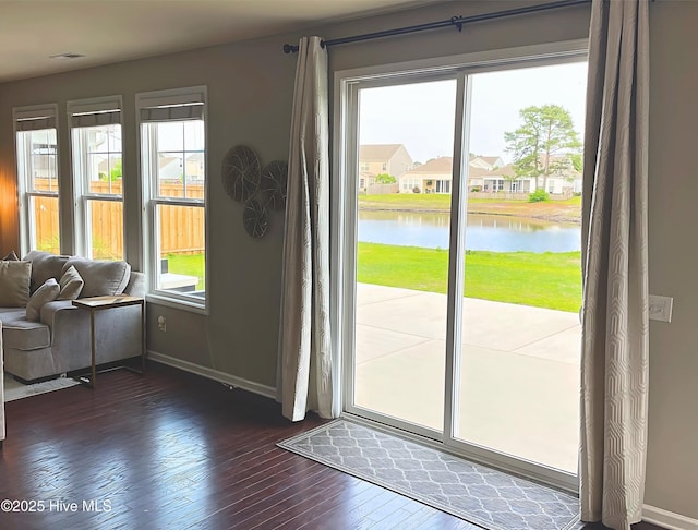 7408 Darius Dr, Wilmington, NC 28411 - doorway to outside with healthy amount of natural light, dark wood-style floors, and a water view
