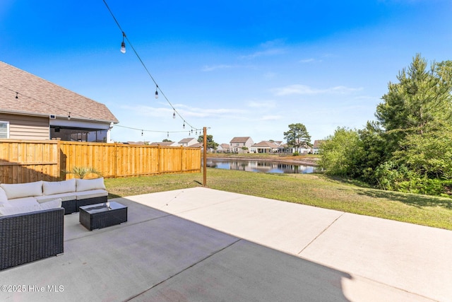 view of patio featuring a water view, fence, and an outdoor hangout area