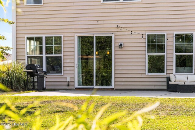 7408 Darius Dr, Wilmington, NC 28411 - doorway to property with a patio and a lawn