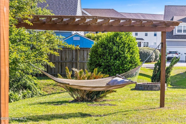 view of yard featuring fence and a pergola