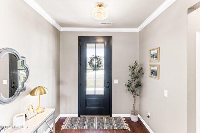 foyer with visible vents, crown molding, baseboards, and dark wood-type flooring