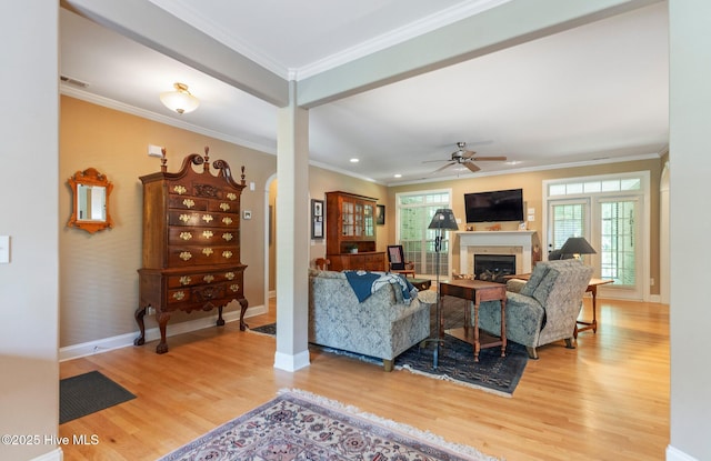 3603 Seafoam Ct, New Bern, NC 28562 - living area with light wood finished floors, crown molding, baseboards, a fireplace, and a ceiling fan