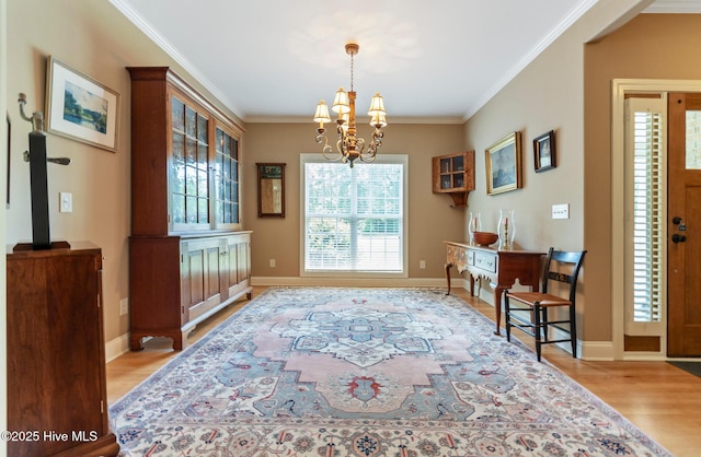 3603 Seafoam Ct, New Bern, NC 28562 - dining space featuring light wood-style flooring, crown molding, a chandelier, and baseboards