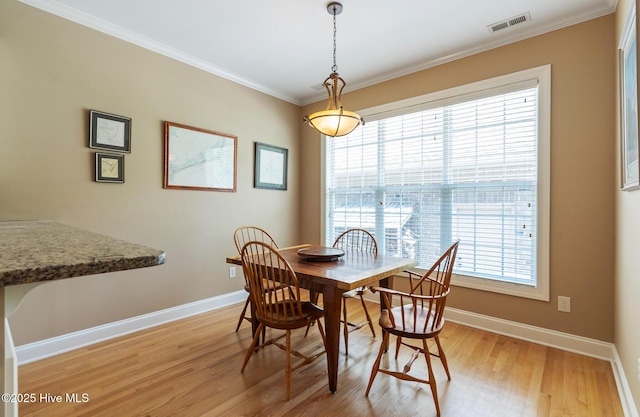 3603 Seafoam Ct, New Bern, NC 28562 - dining room with light wood-style flooring, baseboards, and ornamental molding