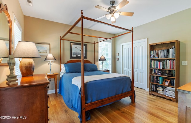 3603 Seafoam Ct, New Bern, NC 28562 - bedroom with light wood-type flooring, multiple windows, a ceiling fan, and baseboards
