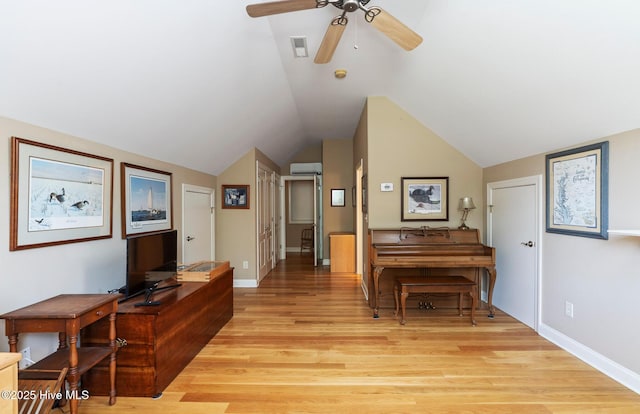 3603 Seafoam Ct, New Bern, NC 28562 - sitting room featuring an AC wall unit, ceiling fan, light wood finished floors, vaulted ceiling, and baseboards