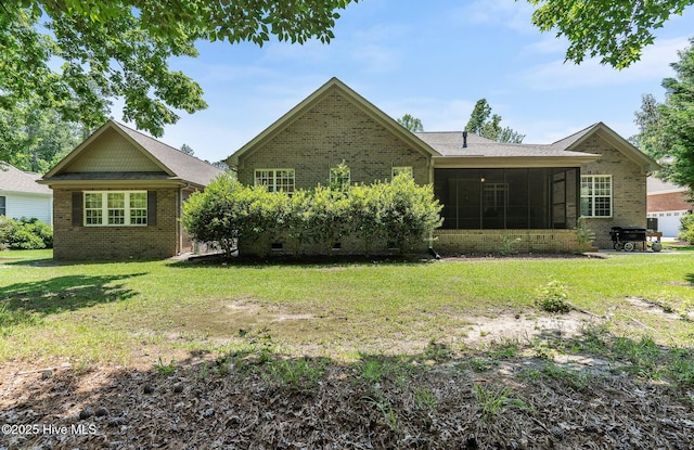 3603 Seafoam Ct, New Bern, NC 28562 - back of property with brick siding, a lawn, and a sunroom