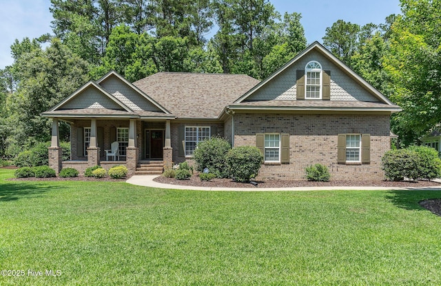 3603 Seafoam Ct, New Bern, NC 28562 - craftsman inspired home with brick siding, covered porch, a front yard, and a shingled roof