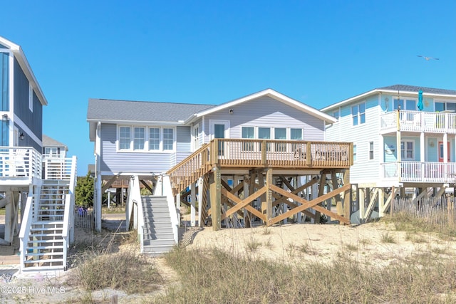 rear view of house with stairs and a carport