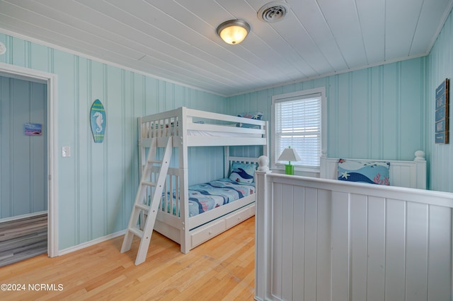 bedroom featuring wood ceiling, wood finished floors, and visible vents