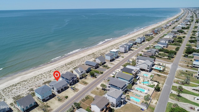 birds eye view of property with a beach view and a water view