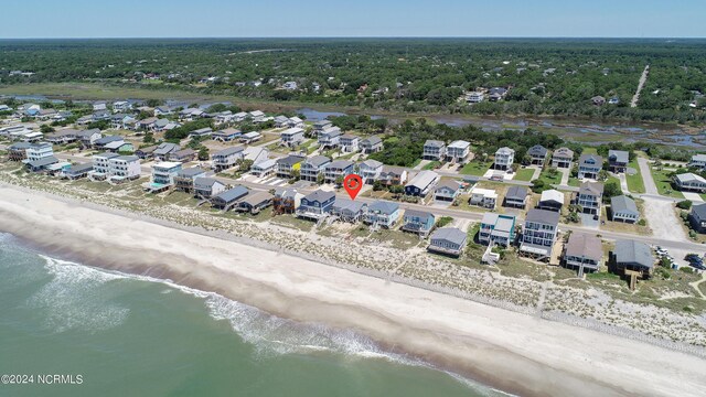 bird's eye view featuring a view of the beach, a residential view, and a water view