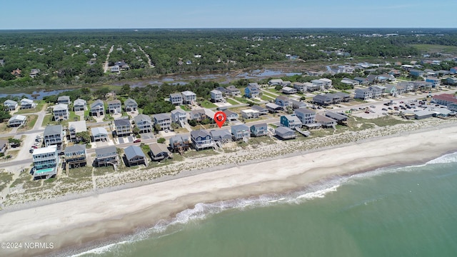 drone / aerial view featuring a beach view and a water view
