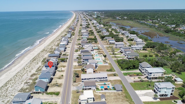 drone / aerial view featuring a beach view and a water view