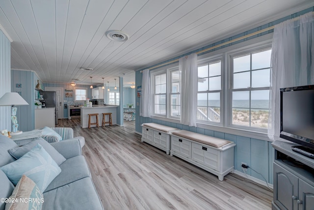 living room featuring wood ceiling, visible vents, and light wood-style floors