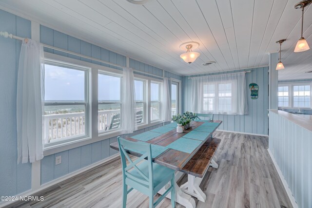 dining room featuring wooden ceiling, light wood finished floors, and baseboards