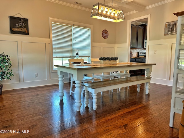 204 Liana Pl, Hubert, NC 28539 - dining space featuring a decorative wall, ornamental molding, wainscoting, and dark wood-type flooring