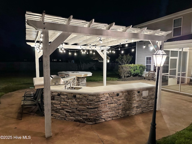204 Liana Pl, Hubert, NC 28539 - patio at night featuring exterior kitchen and a pergola
