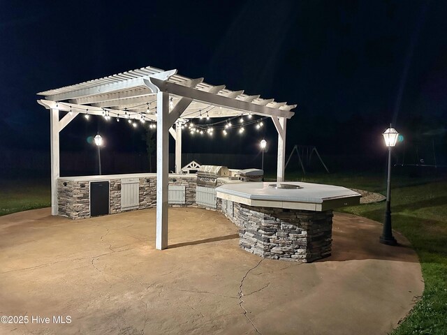 204 Liana Pl, Hubert, NC 28539 - patio at night featuring area for grilling and a pergola