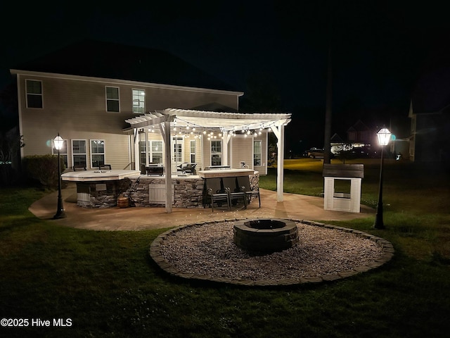 204 Liana Pl, Hubert, NC 28539 - back of house at twilight featuring a fire pit, a pergola, a patio, and a yard