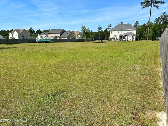 204 Liana Pl, Hubert, NC 28539 - view of yard featuring a trampoline and a residential view