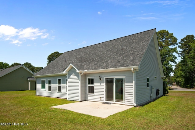 rear view of house featuring a patio area, roof with shingles, and a yard