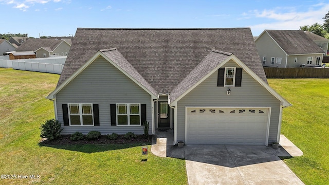 view of front of home featuring fence, driveway, roof with shingles, and a front yard
