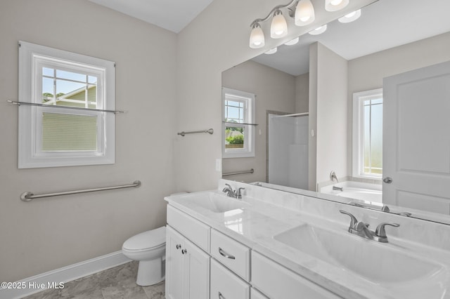full bath with a sink, baseboards, a stall shower, and a garden tub