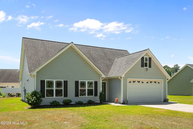 view of front of home featuring a garage, a shingled roof, concrete driveway, and a front lawn