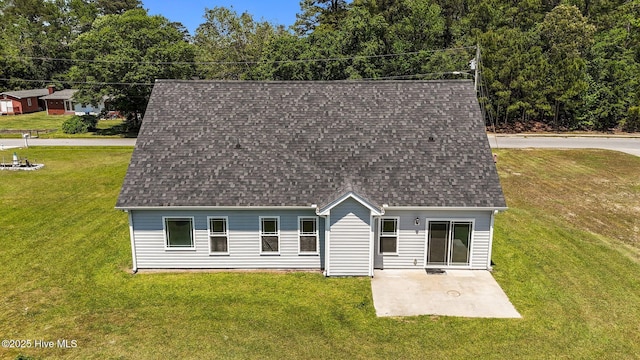 cape cod home with a patio, a front yard, and roof with shingles
